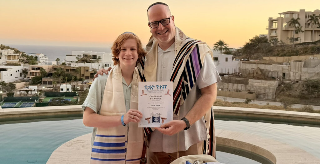 Rabbi officiating a destination bar mitzvah ceremony for a family at a beautiful travel location